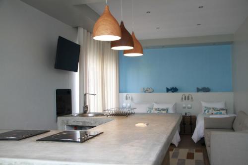 a kitchen and living room with a large counter top at Sea Wind Self Catering Cottages in Swakopmund