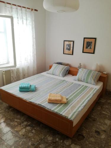 a bedroom with a large bed with two towels on it at Villa Nostra - Kruče in Ulcinj