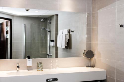 a bathroom with a sink and a mirror at Best Western Plus Savoy Lulea in Luleå