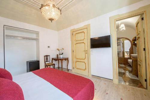 a bedroom with a large bed and a television at Don Antonino Relais in Sorrento