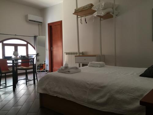 a bedroom with a bed and a table and a window at palermo casa vacanze in Palermo