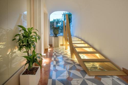 a hallway with a staircase and plants in a building at Don Antonino Relais in Sorrento