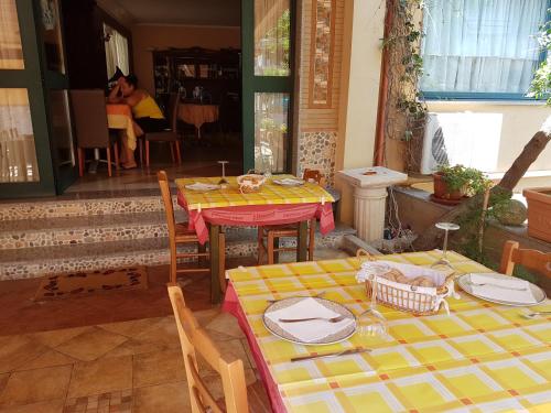 a dining room with two tables with plates on them at Hotel Nautilus in Nicotera Marina