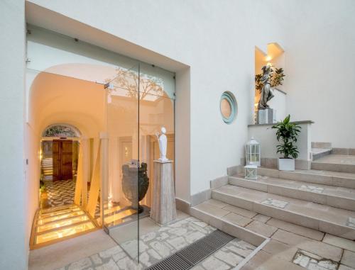 a room with stairs and a glass doorway at Don Antonino Relais in Sorrento