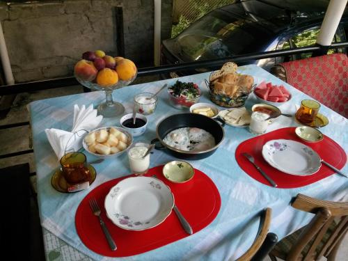 a table with plates and bowls of food on it at Dima's Guesthouse in Tʼelavi