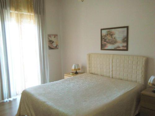 A bed or beds in a room at Appartamento Raffaella