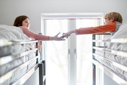 a man and a woman reaching for beds in a hospital at The Barrel Store Cirencester in Cirencester