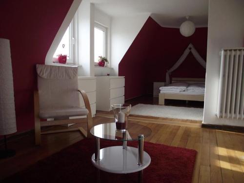 a living room with a table and a bed at Apartments Herzogs Romantik Weimar in Weimar