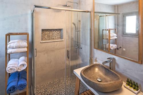 a bathroom with a sink and a shower at Altemar Suites in Fira