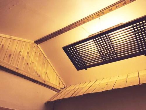 a room with a ceiling with a vent and a window at Eoulim House in Andong
