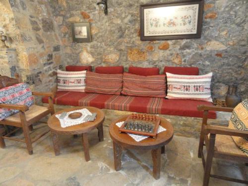 a living room with a couch and two chairs at Zeus House in Agios Konstantinos
