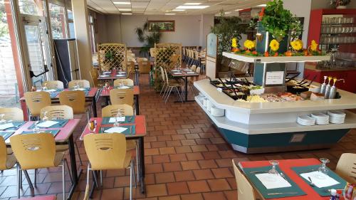 un restaurant avec des tables et des chaises et un buffet dans l'établissement Le Cormoran, à Gonfreville-l'Orcher