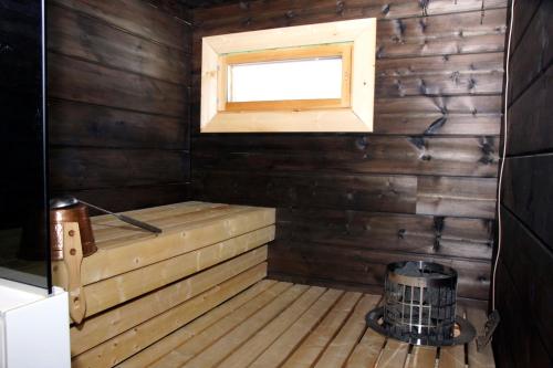 a room with a sauna with a window at Villa Kuukkeli in Salla