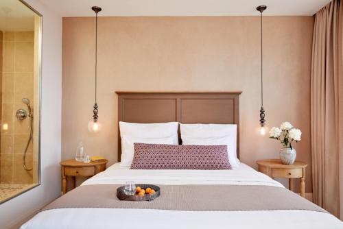 a bedroom with a bed with a bowl of fruit on it at Nido, Mar-Bella Collection in Agios Ioannis Peristeron