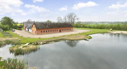 an aerial view of a building next to a lake at Ringslund B&B in Galten