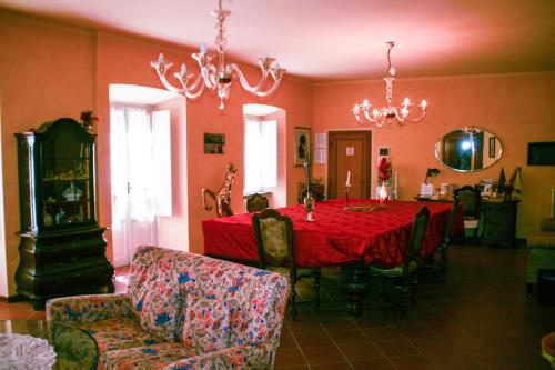 comedor con mesa roja y sillas en Antica Cittadella B&B, en Arezzo