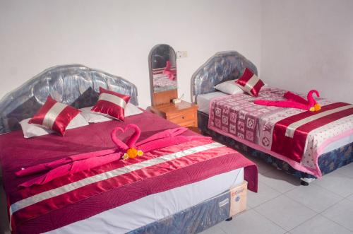 Tempat tidur dalam kamar di Kabera Bungalow Ubud