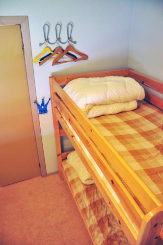 a bedroom with a bed with hangers on the wall at Vimmerby Vandrarhem in Vimmerby