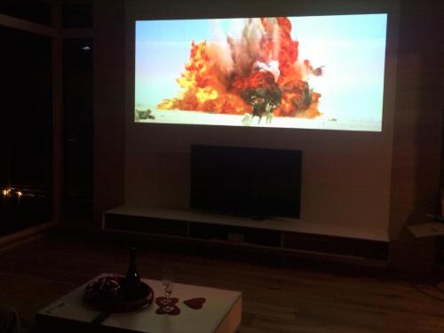 a big screen tv with a video game on it at Brauhaus 3 - Adults only in Königsberg in Bayern