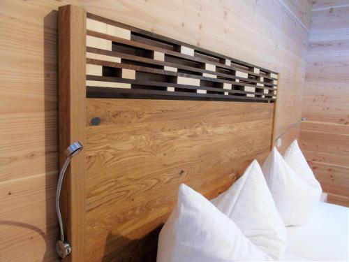 a bedroom with a bed with a wooden headboard at Brauhaus 3 - Adults only in Königsberg in Bayern