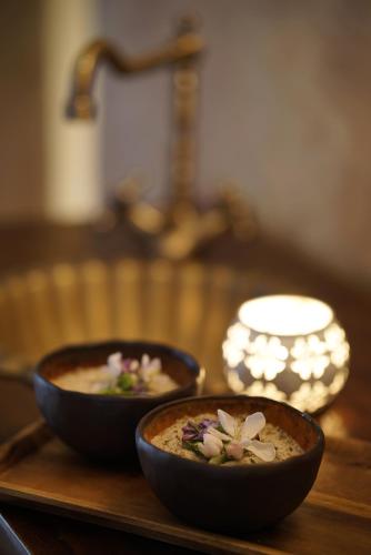 two bowls of food sitting on a wooden table at Liepupe Manor in Liepupe