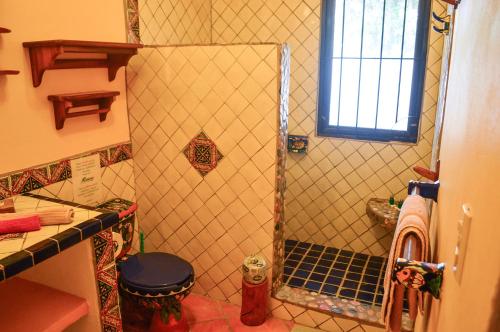 a shower with a glass door in a bathroom at Hotel Casamar Suites in Puerto Escondido