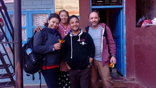 a group of people standing in front of a building at Bandipur Samira Homestay & Mountain View Restaurant in Bandīpur