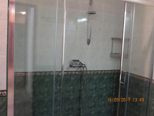 a shower in a bathroom with a glass door at Bogorodi Terrace Apartment in Burgas