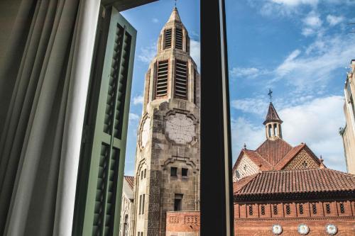 a tall clock tower in front of a building at Sant Jordi Hostels Rock Palace in Barcelona