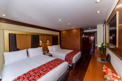 Postel nebo postele na pokoji v ubytování Yawar Inka Hotel