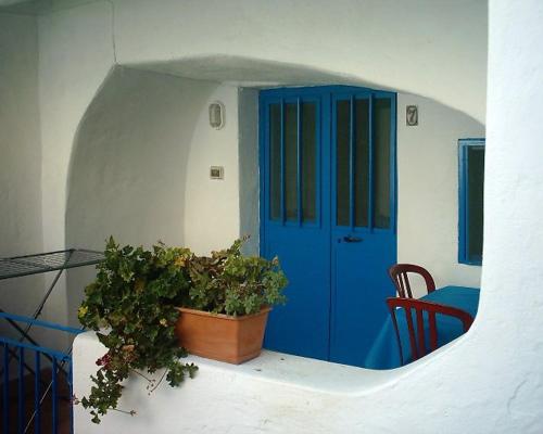 a blue door with a plant in front of it at Case Vacanze Levante in Vulcano