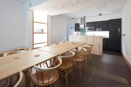 a large dining room with a long table and chairs at The Barrel Store Cirencester in Cirencester