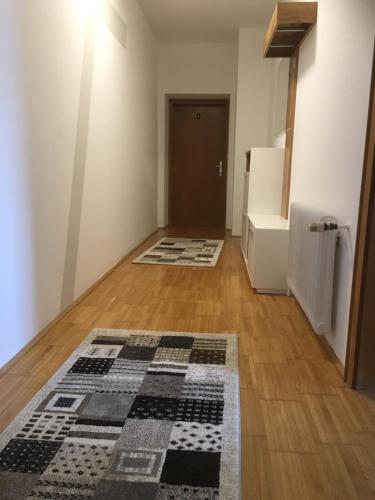 an empty room with a rug on a wooden floor at Frühstückspension Scharinger Hof in Gilgenberg am Weilhart