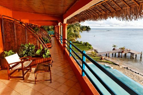 a balcony of a house with a view of the ocean at Hotel Vanivola & SPA in Sainte Marie