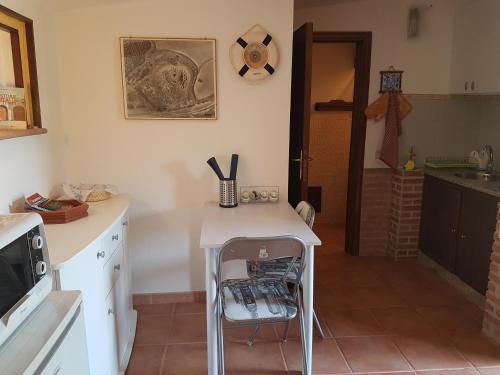 a kitchen with a table and a chair in it at MareSole a Capitana in Capitana