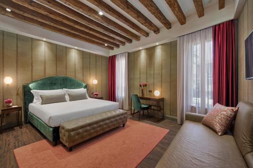 a bedroom with a bed and a chair and a couch at Suite735 in Venice
