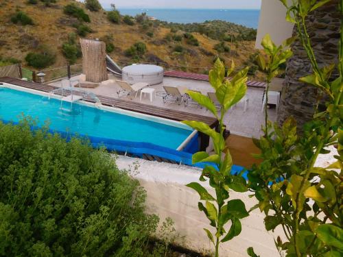 a swimming pool with a view of the ocean at Saronic Citadel in Salamina