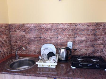 a kitchen counter with a sink and a mixer at House near The Black Sea in Makhinjauri