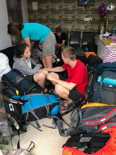 a group of people sitting in a pile of luggage at Palm Rivera Kochi in Cochin