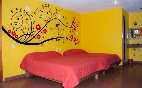 A bed or beds in a room at Hotel Quetzalcalli