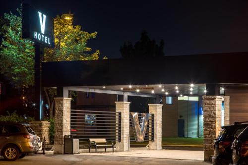 a gas station with a sign at night at Hotel V in Gatineau