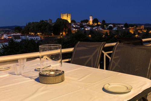 a table with a glass vase on top of a balcony at Pousada de Bragança - Sao Bartolomeu in Bragança