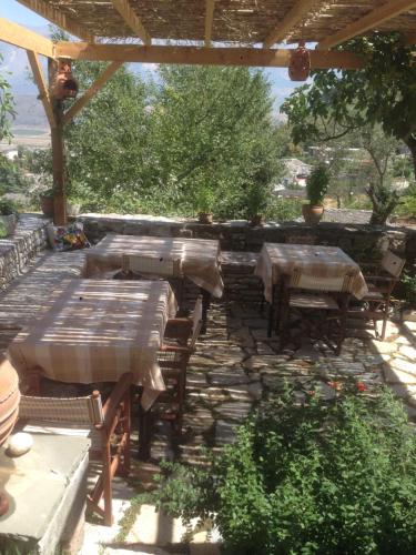 a group of tables and chairs on a patio at Konaku Guest house in Gjirokastër