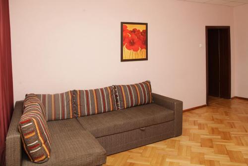 a living room with a couch and a painting on the wall at Apartments on Moskovskaja in Dnipro