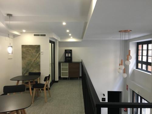 a living room with a table and chairs and a staircase at MD Design Hotel - Portal del Real in Valencia