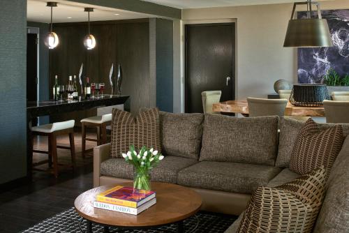 a living room with a couch and a table with books at Revere Hotel Boston Common in Boston