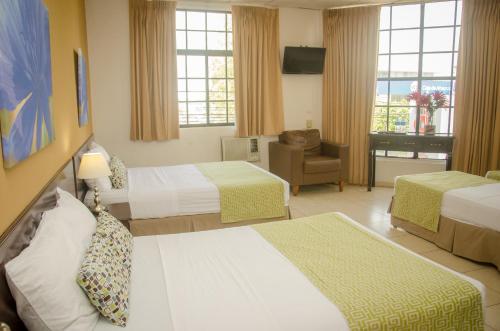 Säng eller sängar i ett rum på Hotel Residencial Cervantes