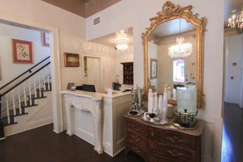 a room with a mirror and a vanity with a counter at Andrew Jackson Hotel French Quarter in New Orleans