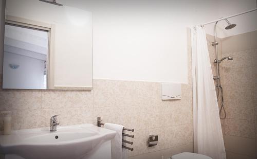 a bathroom with a sink and a toilet and a mirror at Masseria D'Aprile in Castellaneta