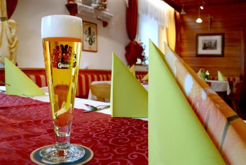 a glass of beer sitting on top of a table at Landgasthof Buchner in Admont
